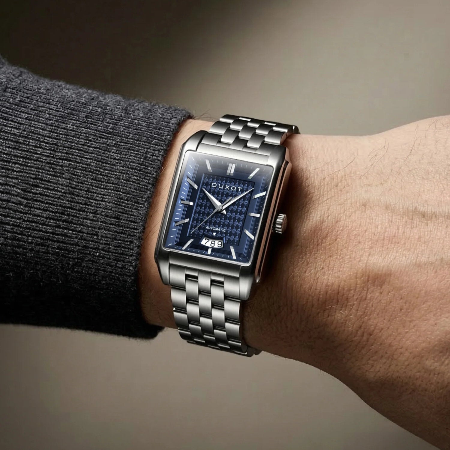Automatikuhr auf einem Handgelenk mit elegantem Edelstahlarmband und blauem Ziffernblatt