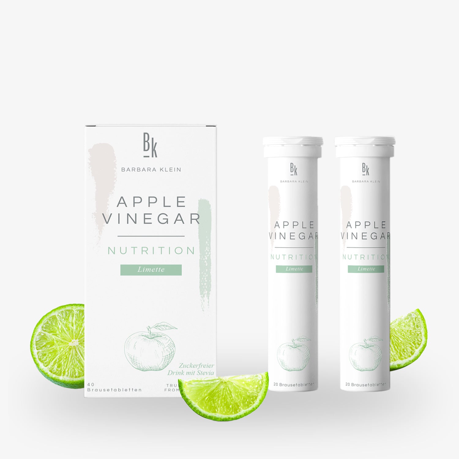 Verpackung und Röhrchen von Apfelessig-Brausetabletten mit Limettengeschmack, daneben Limettenscheiben.