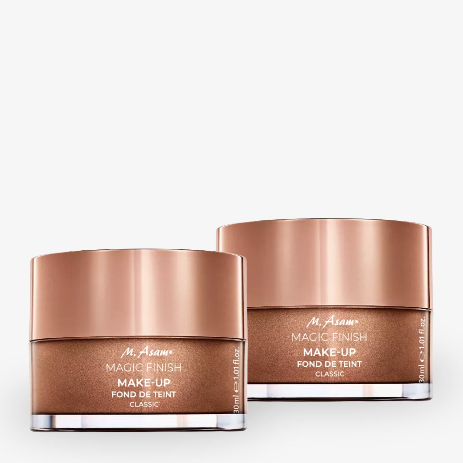 Zwei rosé-goldene Dosen mit M. Asam Magic Finish Make-up auf weißem Hintergrund.