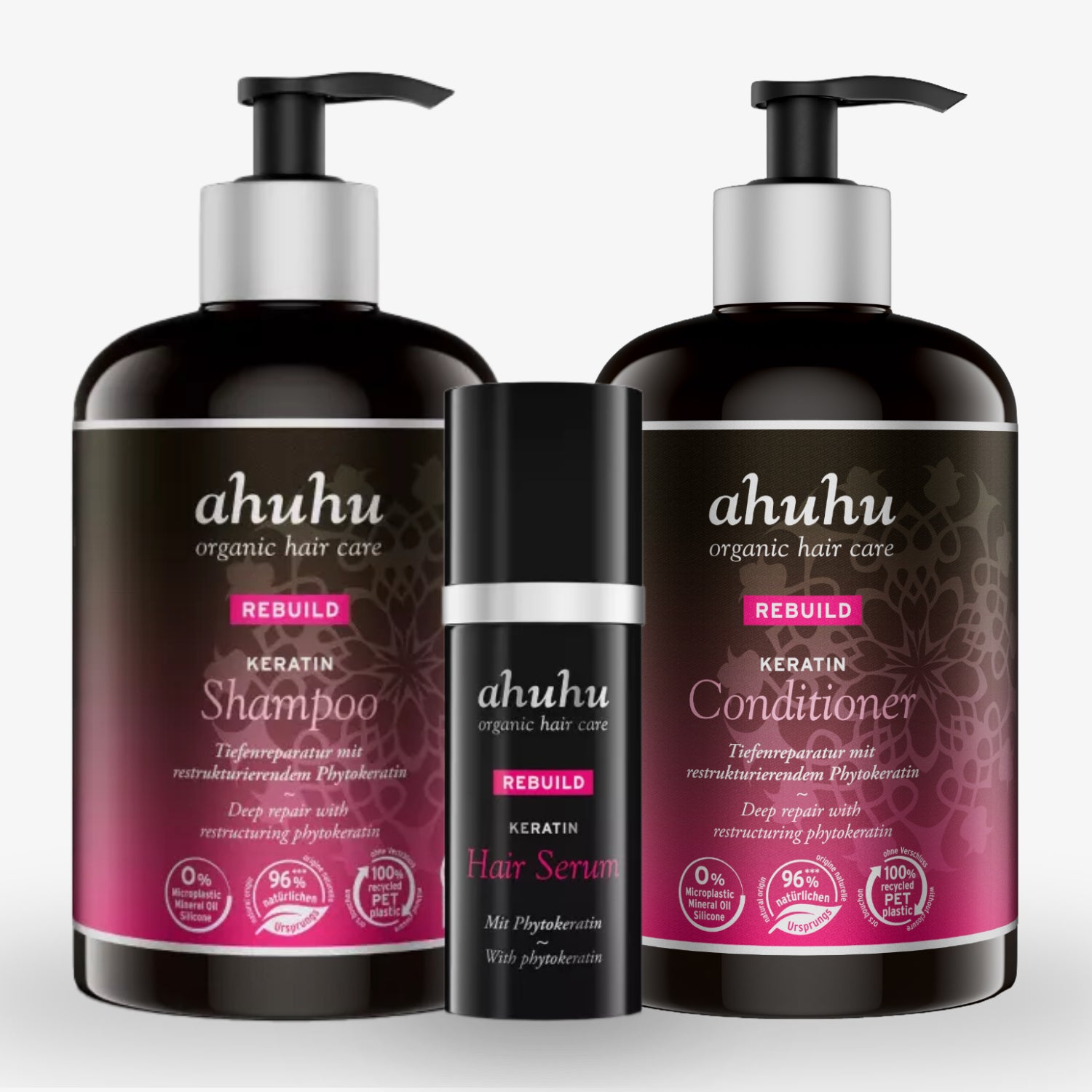 Drei Haarpflegeprodukte von ahuhu mit Keratin: Shampoo, Conditioner und Haarserum mit floralem Design auf den Etiketten.