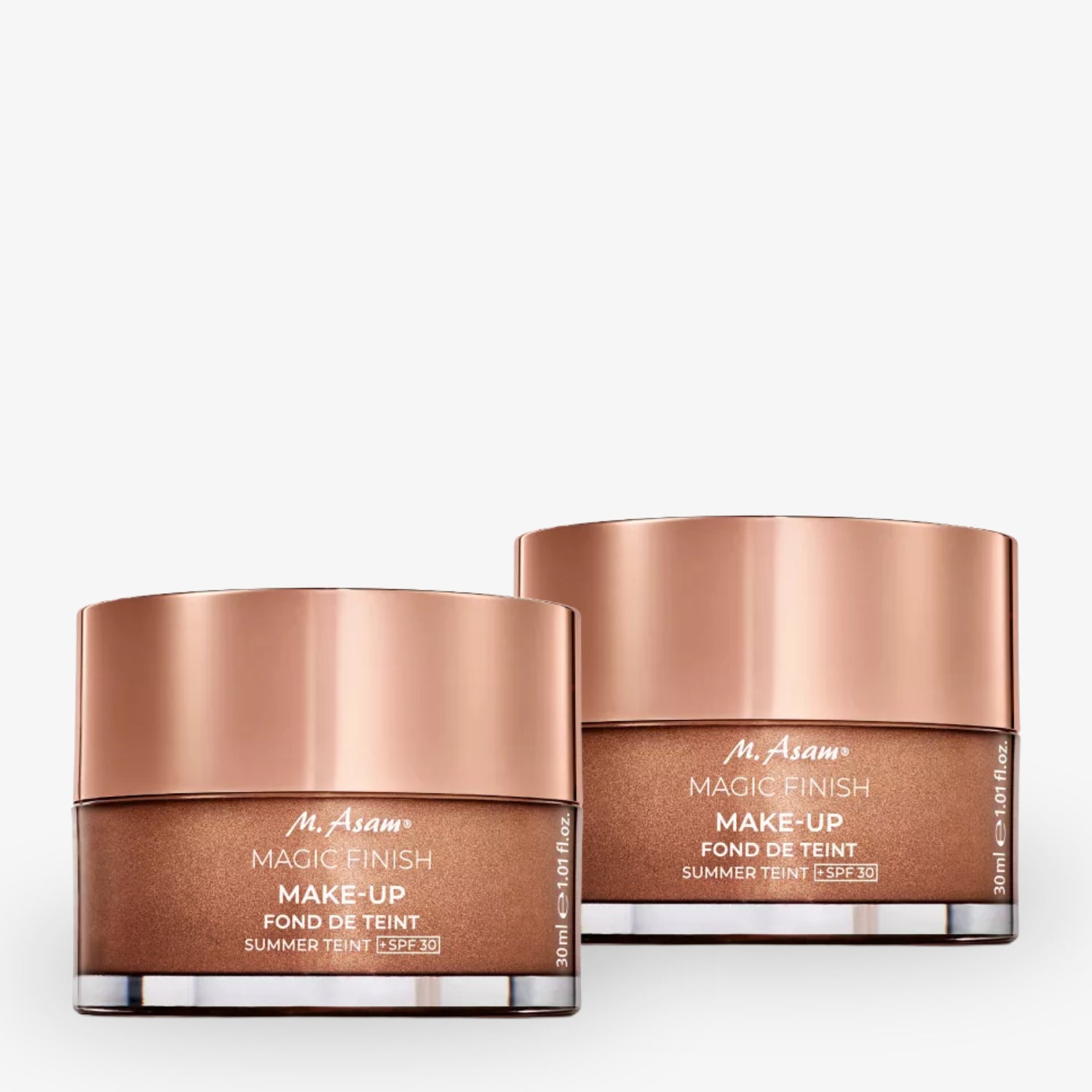 Zwei Tiegel Make-up von "M. Asam Magic Finish" mit bronzefarbenen Deckeln und der Aufschrift "Fond de Teint SPF 30".