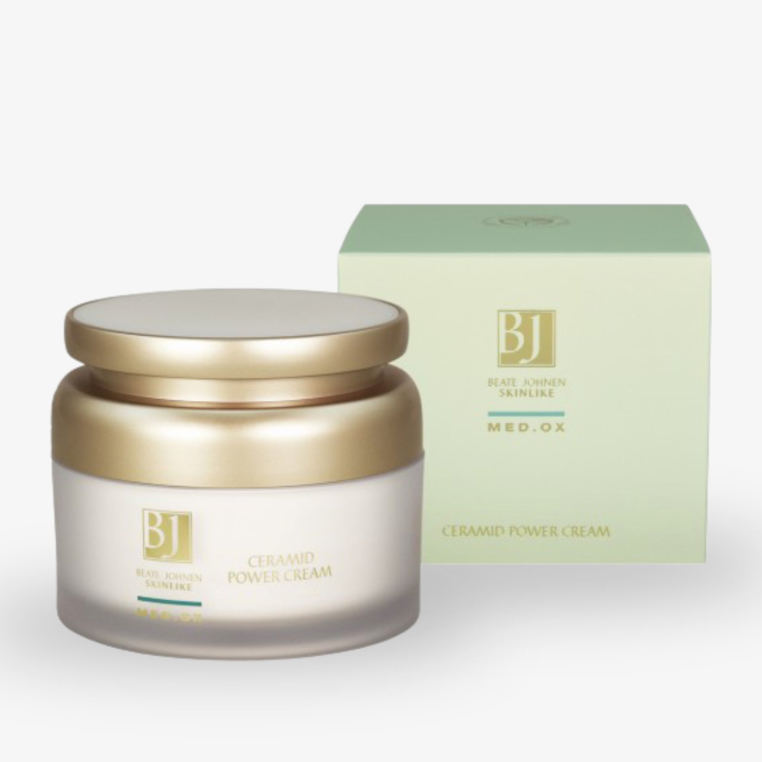 Glasbehälter mit goldfarbenem Deckel neben einer grünen Verpackung mit der Aufschrift „Ceramid Power Cream“.