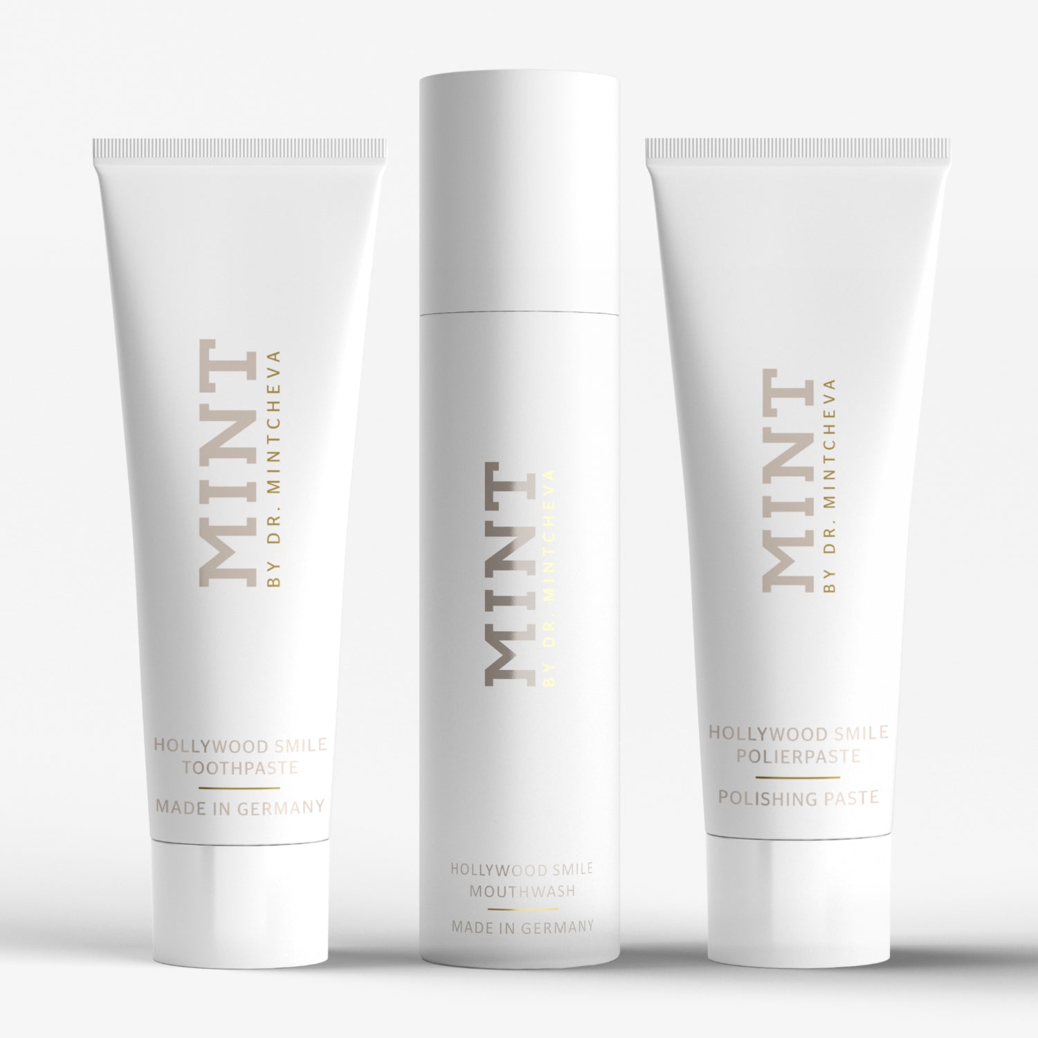 Drei weiße Zahnpflegeprodukte von "MINT by Dr. Mintcheva" mit Zahnpasta, Mundwasser und Polierpaste auf weißem Hintergrund.