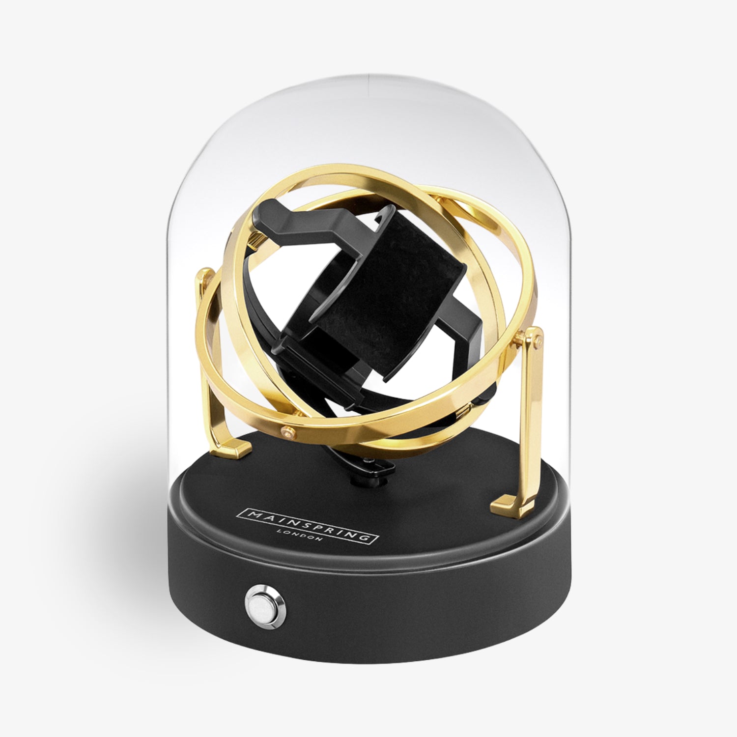 Moderne Uhrendrehbox mit goldfarbenen Ringen unter einer Glaskuppel, auf schwarzem Sockel mit Drehknopf.