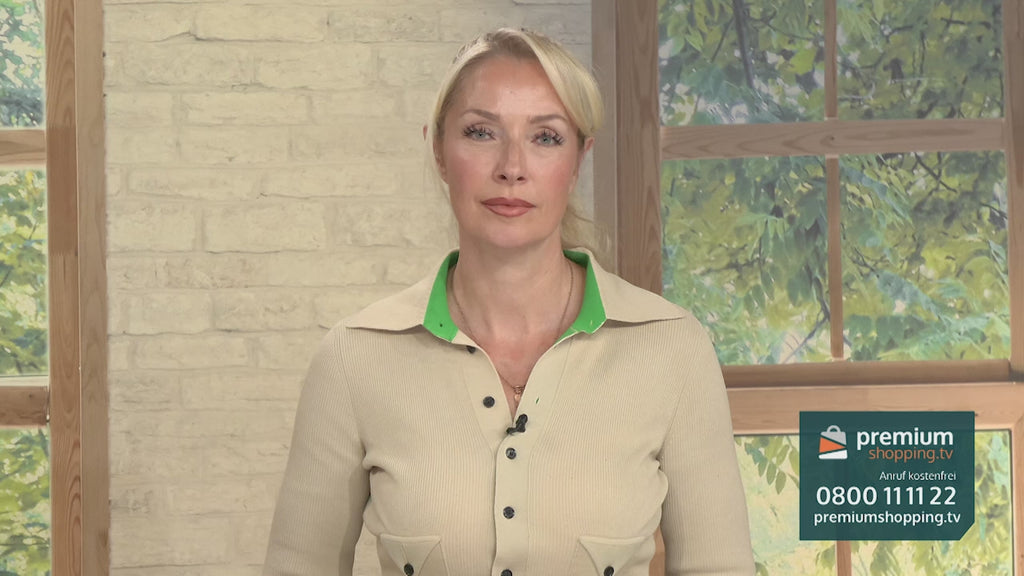 Video-Vorschaubild: Blonde Moderatorin in beige-grünem Oberteil vor einer Backsteinwand und einem Fenster, unten rechts das premiumshopping.tv-Logo mit Telefonnummer.