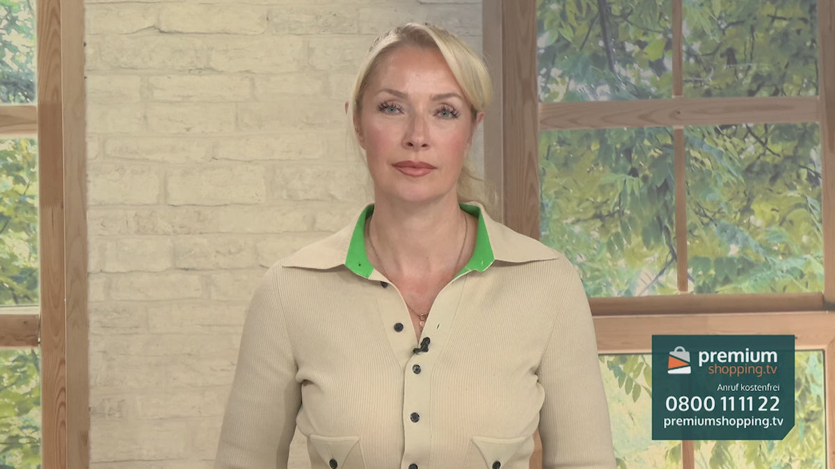Video-Vorschaubild: Blonde Moderatorin in beige-grünem Oberteil vor einer Backsteinwand und einem Fenster, unten rechts das premiumshopping.tv-Logo mit Telefonnummer.