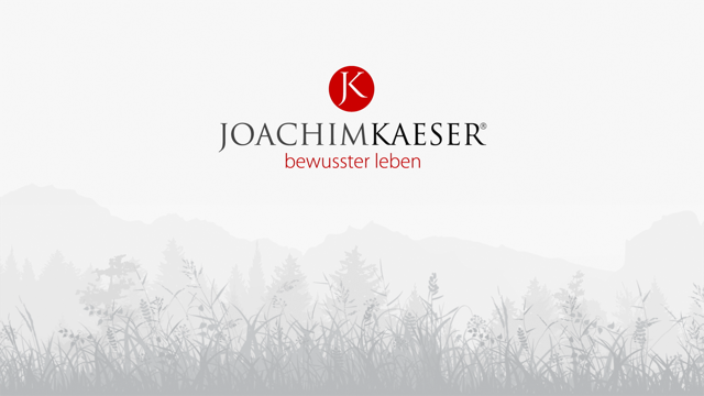 Grauer Hintergrund mit einem transparenten, lächelnden Gesicht darübergelegt.
