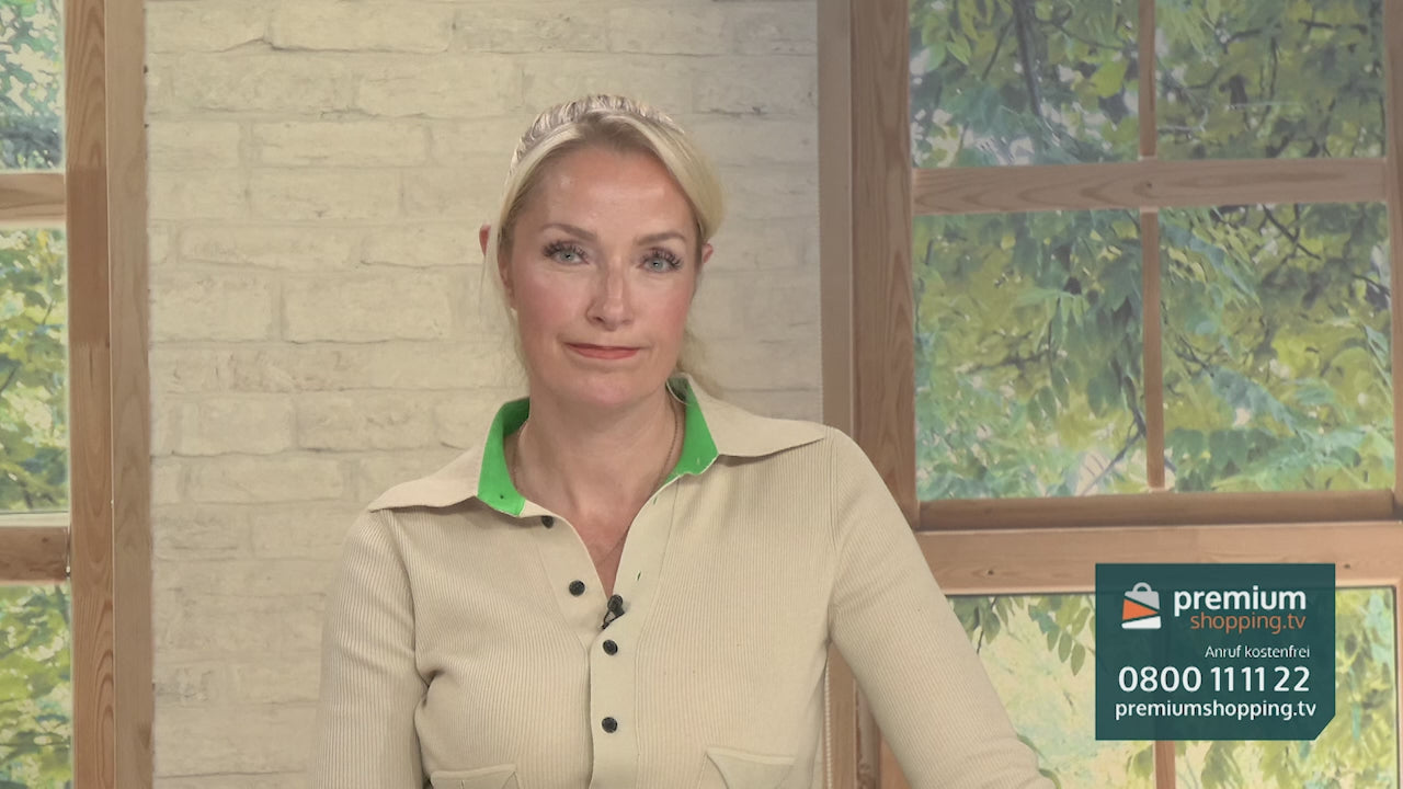Video-Vorschaubild: Blonde Moderatorin in beige-grünem Oberteil vor einer Backsteinwand und einem Fenster, unten rechts das premiumshopping.tv-Logo mit Telefonnummer.